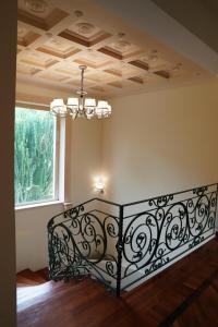 a bedroom with a wrought iron bed in a room with a window at Villa Princi in Villa San Giovanni