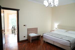 En eller flere senge i et værelse på Villa Princi