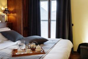 a bed with a tray of food on top of it at Maison Paquier - Central Family Escape in Valtournenche +41 photos