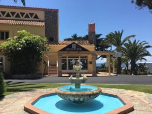a fountain in front of a building at Macdonald Leila Playa Resort in La Cala de Mijas