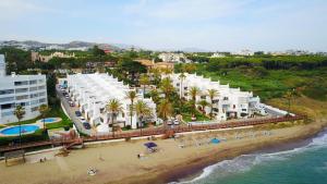 an aerial view of a beach with white buildings at Macdonald Leila Playa Resort in La Cala de Mijas