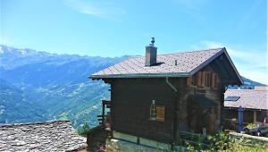 a house on a hill with mountains in the background at Chalet "Chez Claudine et Charles" in Mase