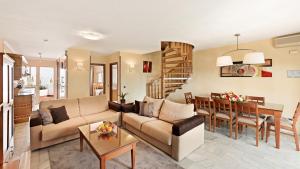 a living room with a couch and a table at Macdonald Leila Playa Resort in La Cala de Mijas