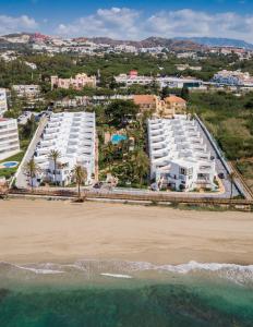 an aerial view of a beach and buildings at Macdonald Leila Playa Resort in La Cala de Mijas