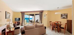a living room with a couch and a table at Macdonald Leila Playa Resort in La Cala de Mijas