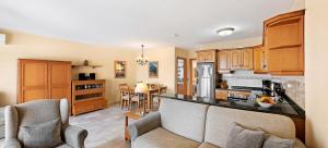a kitchen with wooden cabinets and a counter top at Macdonald Leila Playa Resort in La Cala de Mijas