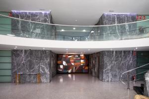 a lobby with marble walls and a painting on the wall at Eurostars Acteón in Valencia