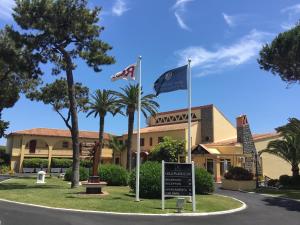 a building with two flags in front of it at Macdonald Leila Playa Resort in La Cala de Mijas