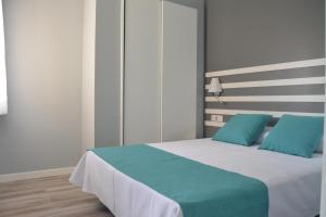 a bedroom with a bed and a dresser at Apartamentos RF Bambi Adults Only in Puerto de la Cruz