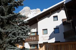a hotel with the mountains in the background at Frara Residence Apartments in San Cassiano