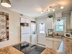 a kitchen with white cabinets and a white refrigerator at Bill’s at Gulf Shores in Gulf Shores
