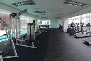 a gym with a row of treadms and machines at Setapak @ Zeta Suite in Kuala Lumpur