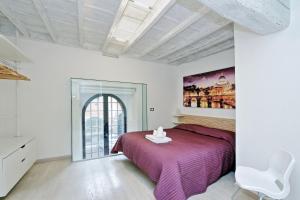 a bedroom with a purple bed and a white chair at Restart Accommodations Borghese in Rome