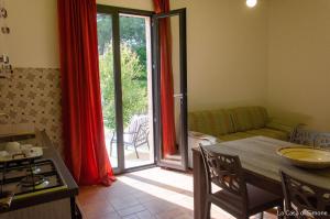 a kitchen and living room with a table and a couch at B&B Terra Cesarea in Santa Cesarea Terme