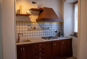 a kitchen with a sink and a stove at Solimena House in Nocera Inferiore