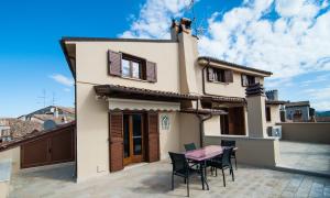 a house with a table and chairs on a patio at Casa Vacanza La Piazza in Orvinio