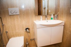 a bathroom with a sink and a toilet and a mirror at Casa Vacanza La Piazza in Orvinio