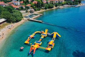 an aerial view of a water slide in the water on a beach at Apartments Andrej in Zadar