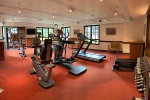 a gym with treadmills and exercise equipment in a building at Arc 1950 3 pièces 6 personnes Luxe Manoir Savoie in Arc 1950