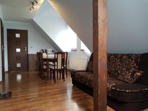 a living room with a couch and a table at Kamienna Polana in Szczytna