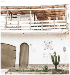 a building with a sign on the side of it at ATMA Hostel & Yoga in Huanchaco