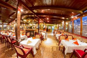 a restaurant with white tables and chairs in a room at Mister Barracuda in Santa Maria