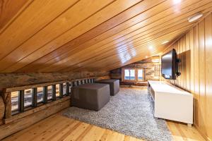 an attic room with wood paneling and a tv at UnelmaKanerva in Ruka