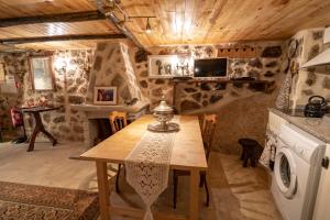 a kitchen with a wooden table and a microwave at SUN SET HOUSE in Monsanto