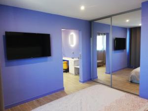 a room with a television and a toilet at Hôtel Saint Roch in Martigues