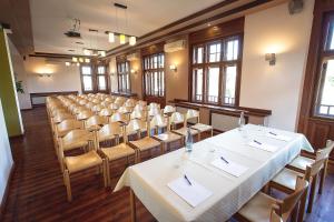 a room with rows of tables and chairs at Castrum Vendégház in Szigetszentmárton