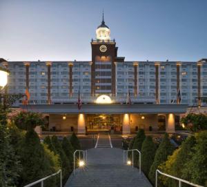 a hotel with a large building with a clock tower at Garden City Hotel in Garden City