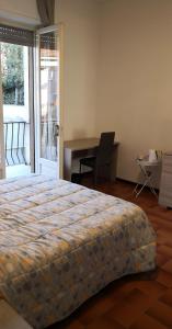 a bedroom with a bed and a desk and a chair at Casa della Sala Spada in Casale Monferrato +13 photos