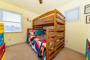 a bedroom with a wooden bunk bed in a room at Swink Cottage in Southern Shores