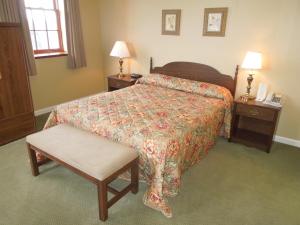 A bed or beds in a room at Bridges Guest Quarters