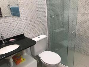 a bathroom with a toilet and a glass shower at Praia do Frances in Praia do Frances +9 photos
