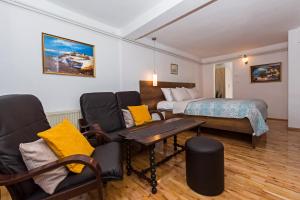 a hotel room with a bed and a table and chairs at INES APARTMENTS in Ohrid