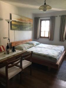a bedroom with a bed and a table and a desk at Altes Presshaus in Eberau