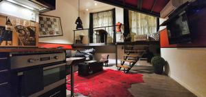 a living room with a red rug on the floor at Apartment RED LOFT Lyon Brotteaux-Part Dieu in Lyon