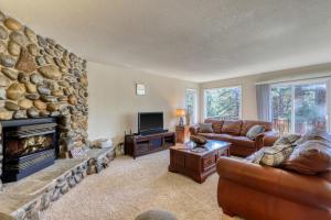 a living room with a large stone fireplace at Cascading Canyon in Zephyr Cove