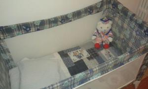 a stuffed teddy bear sitting on top of a bed at Da Anita in Rome