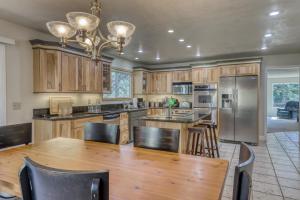 a kitchen with a wooden table and a refrigerator at Cascading Canyon in Zephyr Cove