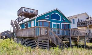 une maison bleue avec deux terrasses au-dessus dans l'établissement Escape to Paradise, à Kitty Hawk