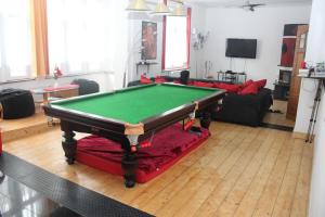 a living room with a pool table on the floor at Privatzimmer Hagen in Hagen