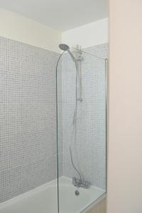 a shower with a glass door in a bathroom at Epicsa - 3 Bedroom Family & Corporate Stay, Garden and FREE parking in Cambridge