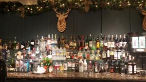 a bar filled with lots of bottles of alcohol at The Swan Hotel in Bibury