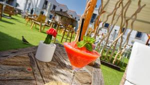 a drink in a glass sitting on a wooden table at FBC Fortuny Resort - Adults Only in Maspalomas