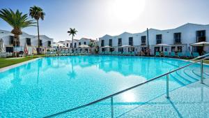 a large swimming pool in front of some buildings at FBC Fortuny Resort - Adults Only in Maspalomas
