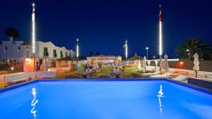 a large swimming pool at night with aidium at FBC Fortuny Resort - Adults Only in Maspalomas