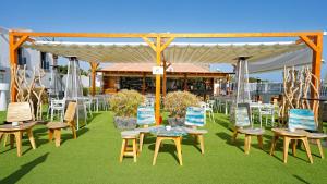 a group of chairs and tables under a pavilion at FBC Fortuny Resort - Adults Only in Maspalomas