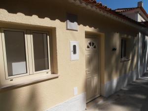 a building with a door and windows on the side of it at Mustache Studio in Ourém